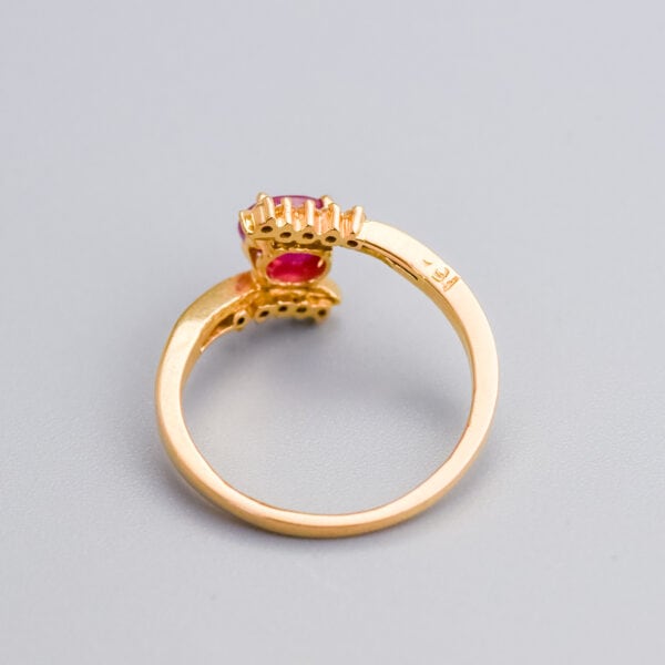 Elegant gold ring with a pink gemstone, featuring intricate setting and craftsmanship, perfect for engagement or special occasions.
