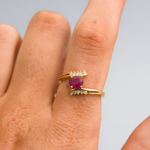 Elegant gold ring featuring a central pink sapphire gemstone and accented with sparkling diamonds, showcasing fine craftsmanship and luxurious design from Don Laurence Jewellery.