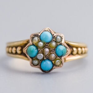 Turquoise and pearl vintage cluster ring in gold with intricate gemstone detailing, perfect for unique jewellery lovers.