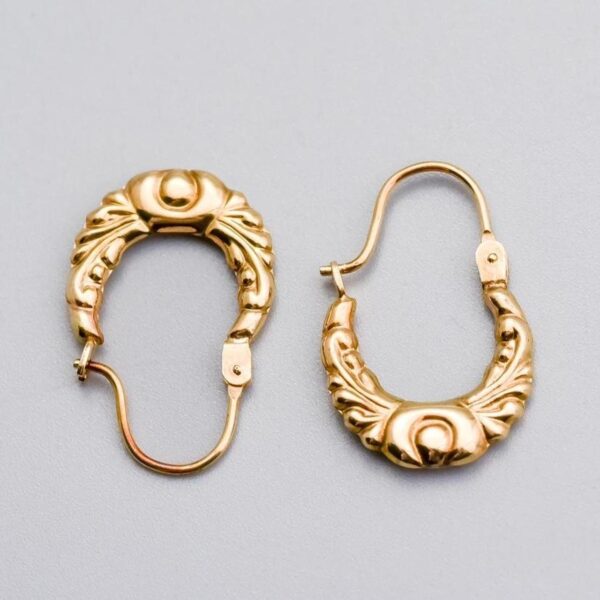 Solid 9K Gold Creole Earrings  This pair of 9K gold creole earrings features a graceful oval design, adorned with intricate Bohemian-style patterns that add a touch of artistry and charm.   The earrin