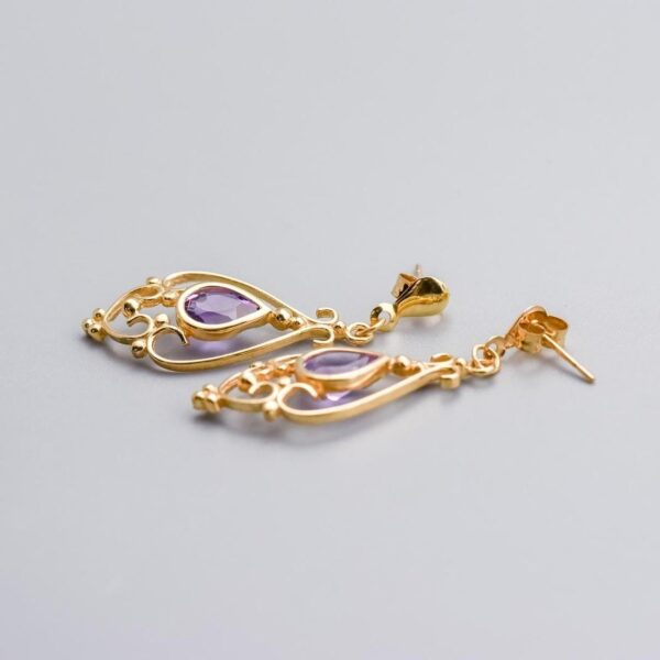 Solid 9K Gold Amethyst Drop Earrings  This pair of 9K gold amethyst drop earrings features a pear-cut amethyst at its centre, elegantly set in a polished gold bezel.   Surrounding the gemstone is intr